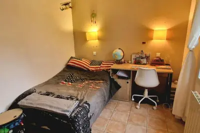 a small bedroom with a bed and a desk at Villa Provençale Harmonie 8 Guest poolhouse in Lambesc