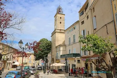 a building with a clock tower on a city street at Villa Provençale Harmonie 8 Guest poolhouse in Lambesc