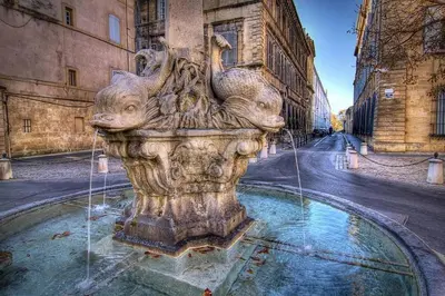 a fountain with two animals on it in a street at Appartement au coeur du centre historique in Aix-en-Provence