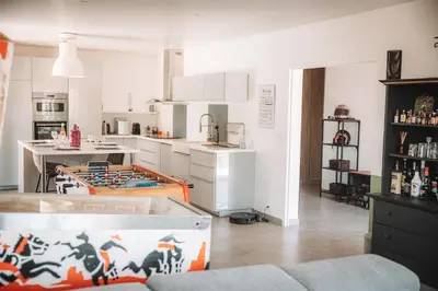 a kitchen with a table in the middle of a room at Villa les trois pins in Venelles