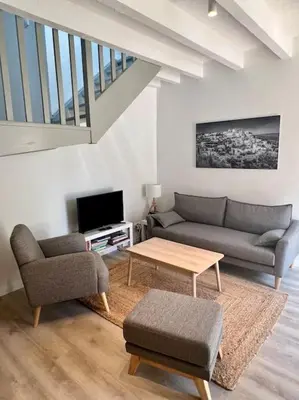 a living room with a couch and a table at Terrasse à Aix en Provence centre historique in Aix-en-Provence