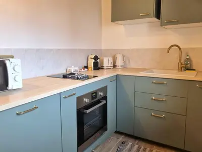 a kitchen with blue cabinets and a stove top oven at Studio lumineux clim - centre ville in Aix-en-Provence
