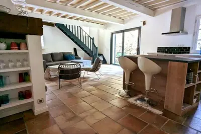 a living room with a table and a couch at Maison Ange & Lice in Pernes-les-Fontaines