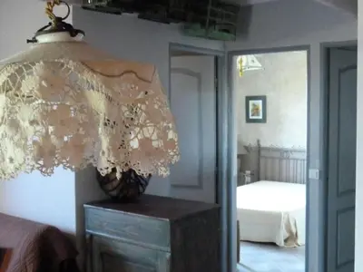 a lamp on top of a dresser in a bedroom at Cottage in Oppède with Poolside Bliss in Maubec