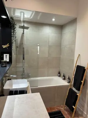 a bathroom with a bath tub and a sink at Appart d exception 2 chambres quartier Mazarin in Aix-en-Provence