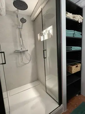 a shower with a glass door in a bathroom at Appart d exception 2 chambres quartier Mazarin in Aix-en-Provence