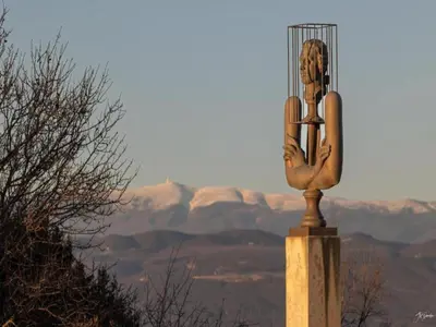 a statue of a woman in a cage on a pole at Holiday Home Provence with Pool in Céreste