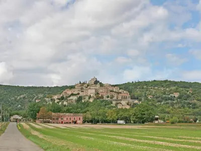 a castle on top of a hill on a field at Holiday Home Provence with Pool in Céreste