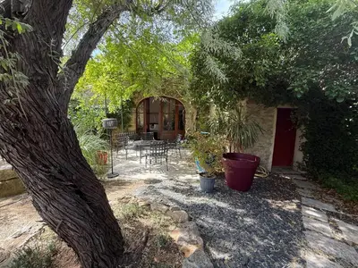 a living room with a bed and a couch at Moulin AURELIA - chambre La Coloniale in Pélissanne
