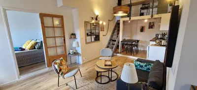 a living room with a couch and a table at Cocon ensoleillé centre ville historique, Clim Wifi 4 people in Aix-en-Provence