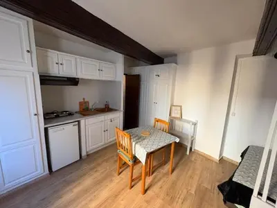 a small kitchen with a table and a table and chairs at Studio Cosy hyper centre Aix in Aix-en-Provence