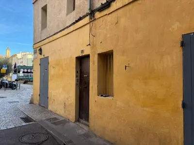 an old building with two doors on the side of it at Studio Cosy hyper centre Aix in Aix-en-Provence