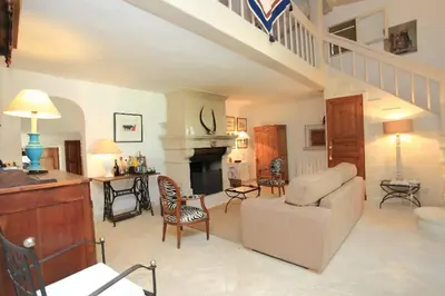 a living room with a couch and a fireplace at Villa La Raffinée, au coeur des garrigues du Luberon in Gordes