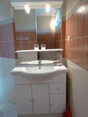 a bathroom with a white sink and a mirror at La Calvinette in Pernes-les-Fontaines