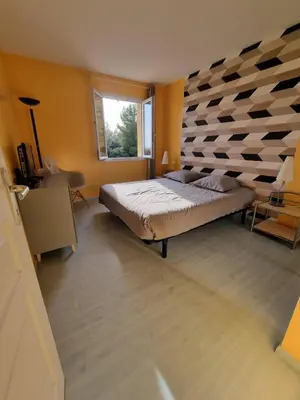 a bedroom with a large bed and a window at villa avec piscine aureille alpilles paragi ls1-449 in Aureille