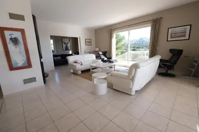 a living room with white furniture and a large window at villa avec piscine aureille alpilles paragi ls1-449 in Aureille