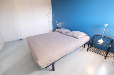 a bedroom with a large bed with a blue wall at villa avec piscine aureille alpilles paragi ls1-449 in Aureille