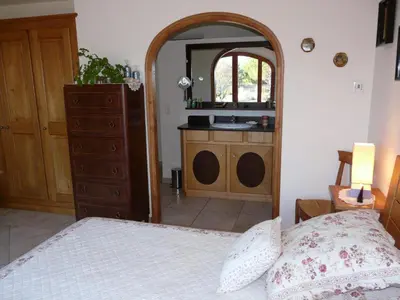 a bedroom with a bed and a dresser and a mirror at Villa avec piscine Saint Remy de Provence LS1-196 in Saint-Rémy-de-Provence