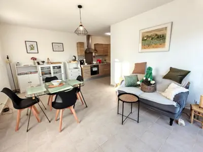 a living room with a couch and a table at Les deux Oliviers in Roussillon