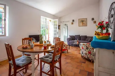 a living room with a table and chairs at Villa Le Bastidon by Villa Plus in Les Taillades