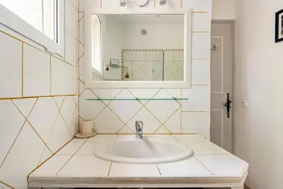 a bathroom with a sink and a mirror at Le cabanon, 3 étoiles, sa piscine au pied du Luberon in Saint-Saturnin-les-Apt