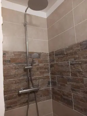 a shower with a shower head in a bathroom at Studio entièrement rénové in Cavaillon