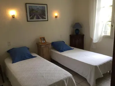 a bedroom with two beds and a picture on the wall at Maison avec piscine privative Taillades Luberon LS2-281 in Les Taillades
