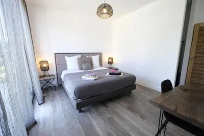 a bedroom with a bed and a table and a desk at Villa avec piscine privative Saint Remy de Provence LS1-340 in Saint-Rémy-de-Provence