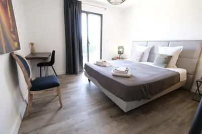 a bedroom with a bed with a chair and a desk at Villa avec piscine privative Saint Remy de Provence LS1-340 in Saint-Rémy-de-Provence