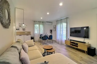 a living room with a couch and a flat screen tv at The Maisonnette in the pines in Ventabren