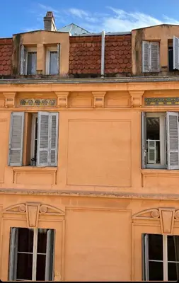 an orange building with windows and a roof at T2 lumineux hyper centre Aix en Provence à quelques metres du Cours Mirabeau pour 1 à 5 personnes in Aix-en-Provence