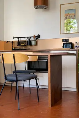 a wooden desk with a chair in a room at La Suite Mazarin in Aix-en-Provence