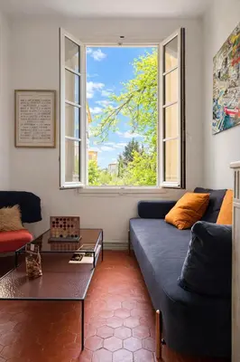 a living room with a large wooden table in it at La Suite Mazarin in Aix-en-Provence