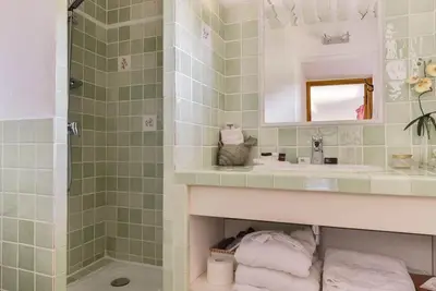 a bathroom with a sink and a shower at Chambre d'hôtes le Jardinage in Cabrières-dʼAvignon