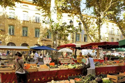 a group of people walking around a farmers market at Chez Monique - Appartement T2 au cœur du centre ville historique - proche Mairie et Cardeurs in Aix-en-Provence