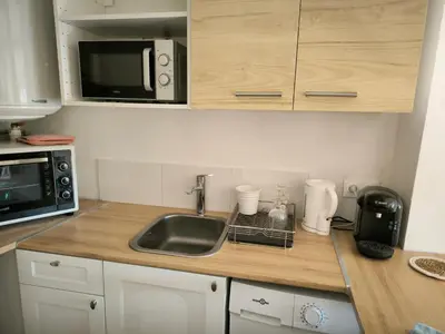 a kitchen with a sink and a microwave at Le Nid plein centre in Salon-de-Provence