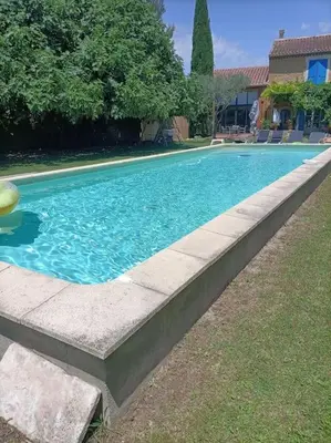 a swimming pool with a ball in the middle at Superbe appartement neuf au cœur de la Provence. in Entraigues-sur-la-Sorgue