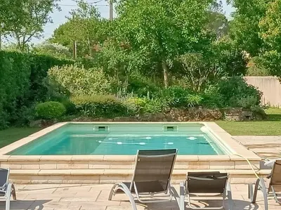 a swimming pool with chairs in front of it at Superbe appartement neuf au cœur de la Provence. in Entraigues-sur-la-Sorgue