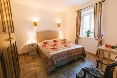 a small bedroom with a bed and a window at Location vacances maison piscine LIOUX LS2-92 in Lioux