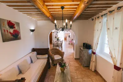 a living room with a couch and a table at Location vacances maison piscine LIOUX LS2-92 in Lioux
