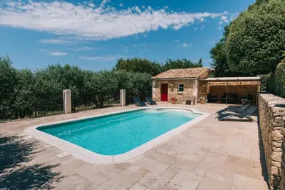 a swimming pool in a yard with a house at Location vacances maison piscine LIOUX LS2-92 in Lioux