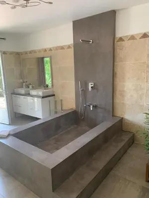 a bathroom with a large tub and a sink at Entre ciel et terre in Le Thor