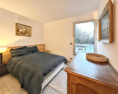 a bedroom with a bed and a window at Maison spacieuse avec piscine à Aix-en-Provence in Aix-en-Provence