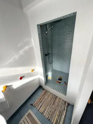 a bathroom with a shower with a glass door at Maison spacieuse avec piscine à Aix-en-Provence in Aix-en-Provence