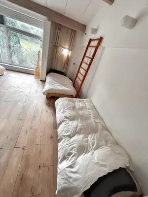 a bedroom with two bunk beds and a ladder at Maison spacieuse avec piscine à Aix-en-Provence in Aix-en-Provence