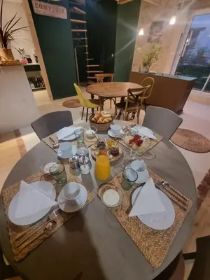a dining table with plates and food on it at Chambre DURFORT in Sault-de-Vaucluse