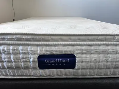 a mattress with a sign on it sitting on a table at Le Clos d'Aix studio 106 parking in Aix-en-Provence