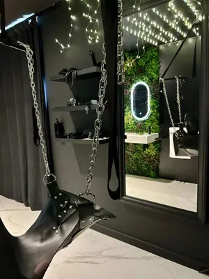 a pair of black boots chained to a window at BDSM TANTRA Love Room Salon-de-Provence in Salon-de-Provence