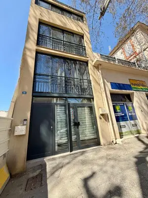a building with a large window on top of it at L'Olivier - Joli duplex au cœur du centre ville à 2 pas de la Rotonde Mirabeau et des allées Provençales in Aix-en-Provence