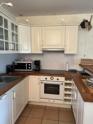 a kitchen with white cabinets and a stove top oven at Bastidon de Gordes in Gordes